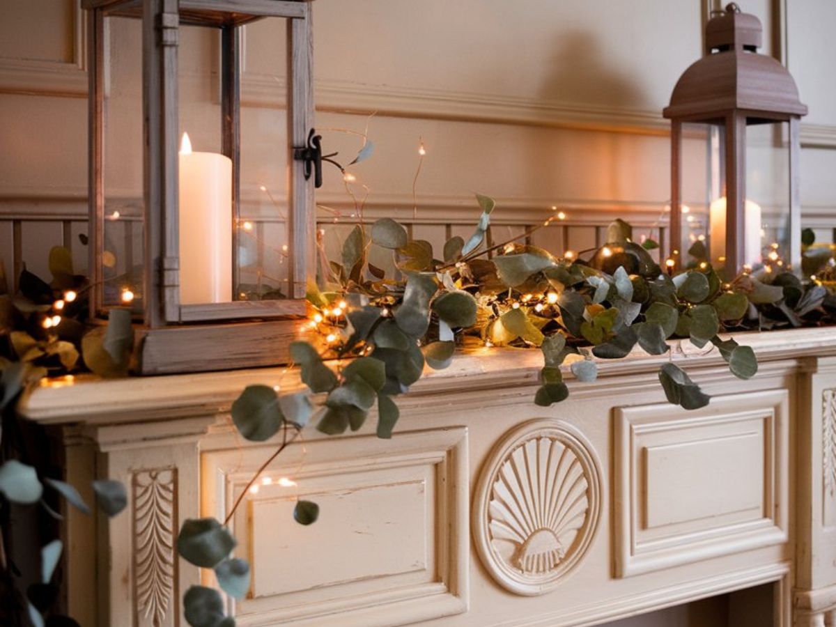 French country-inspired Valentine’s mantel featuring rustic lanterns, eucalyptus, and warm string lights for a cozy and festive look.